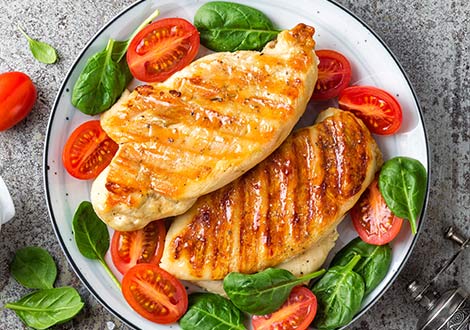    tender chicken breast with tomato and basil on a plate served at Marinis Takeaway in Motherwell 