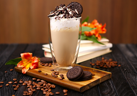 creamy milkshakes with Oreo and coffee beans dressing on a wooden plate served at Marinis Takeaway in Motherwell 